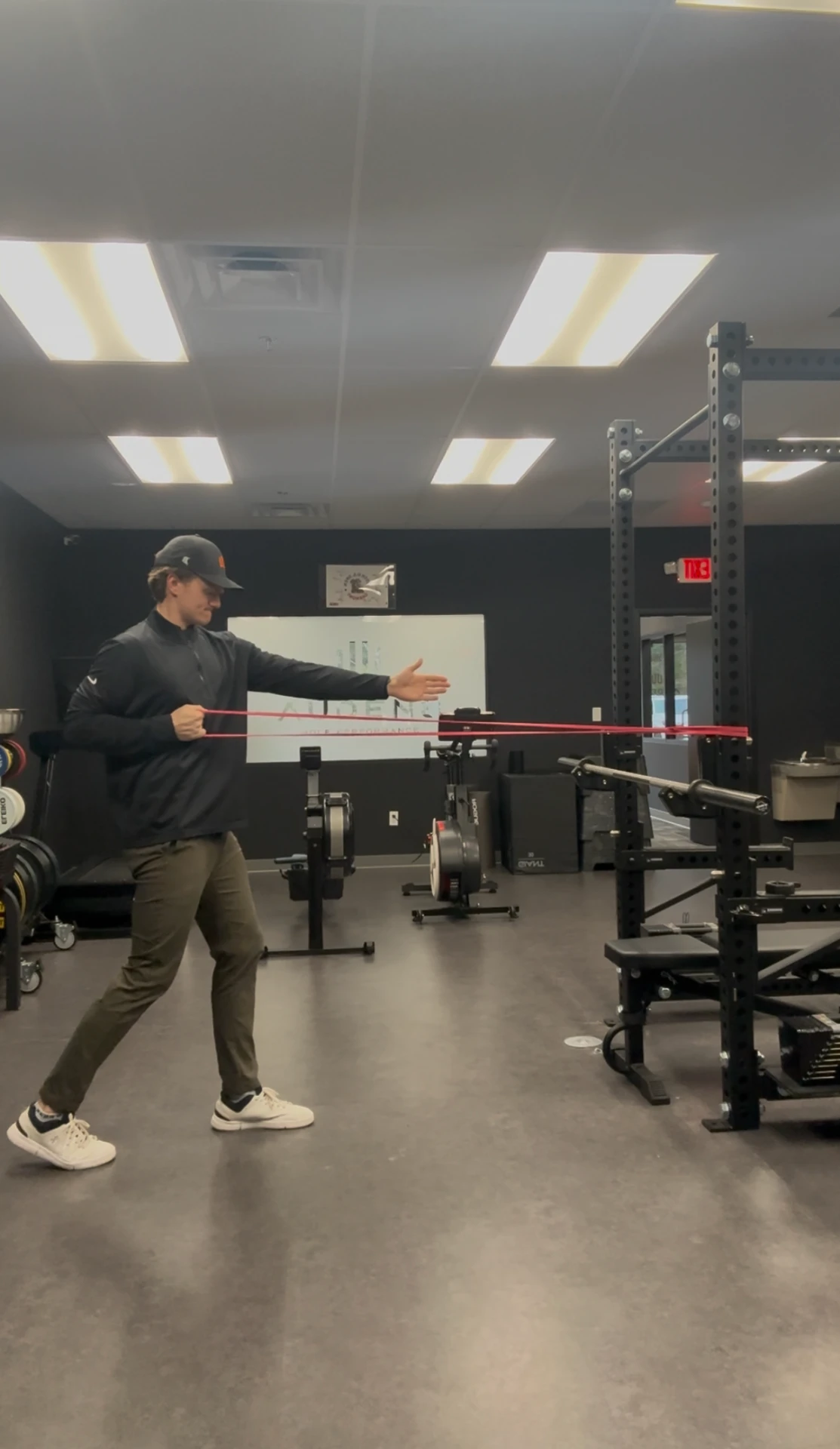 Coach demonstrating a banded rotational drill